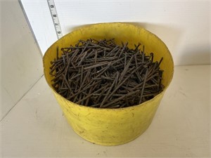 Yellow container full of nails