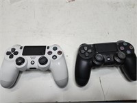 White and black PlayStation wireless controllers.