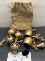 Metal bell ornaments in burlap bag