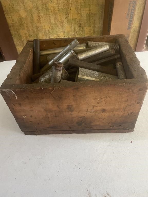 Wooden crate with metal pipe