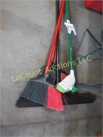 assorted brooms and mop