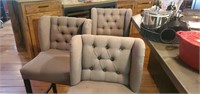 Upholstered tufted back chairs.