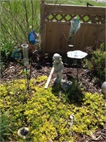Garden stakes and little girl statue