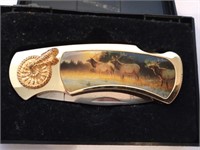 Great gold tone stainless knife with elk pictures