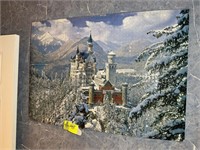 Mounted puzzle of large castle set in winter setti