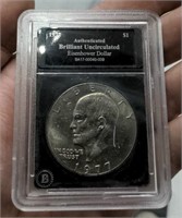 1977 Eisenhower Dollar coin slabbed. Brilliant