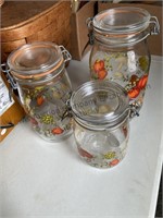 A set of storage jars in 3 different sizes, some