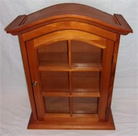 Wooden wall hanging curio cabinet.