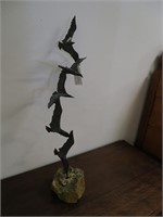 Vintage bronze sculpture of bird flying, on