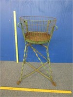 antique green wire basket on metal stand
