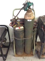 Acetylene and oxygen tanks for welding on cart