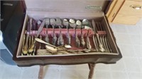 Community Silverware In Wood Cabinet