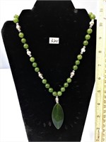 Jade necklace with silver beads and a jade pendant