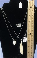 Two necklaces one is a carved ivory bear head the