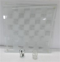 Glass chess board with matching shot glasses.