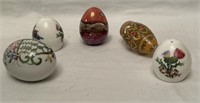 FIVE ceramic and art glass eggs.