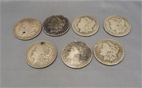 (7) Low grade or problem Morgan silver dollars.