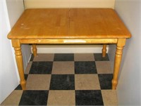 Solid maple kitchen table with extension leaf.