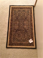 Cheetah print black gold floor rug