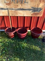 three plastic planters - red