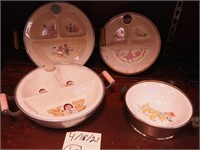 Four baby warming bowls decorated with nursery