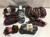Assorted skeins of yarn; 2 knitting needles,starts