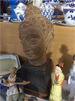 Buddha head on pedestal