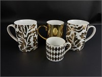 Box lot of gold and white ceramic mugs.