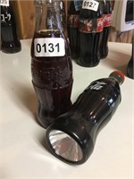 Coke- one flashlight and  1 sealed bottle