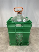 Large 5 gallon glass jug with green crate