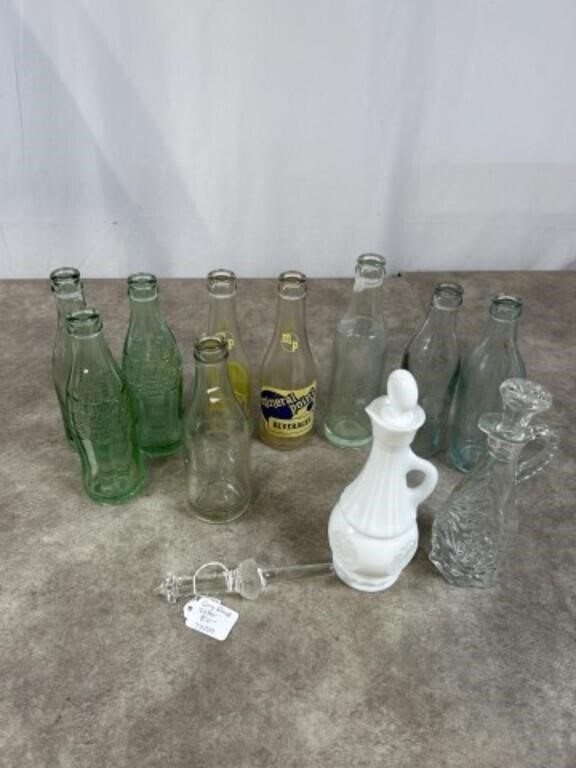 Vintage glass soda bottles, cruets, and glass