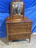 Wood 3 drawer dresser with attached mirror.
