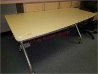 28.5" high asymmetrical table on casters.