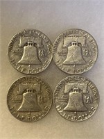 Set of 4 silver half dollar coins.