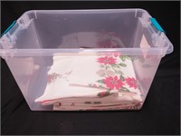 Container of vintage colorful tablecloths, all
