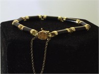 14 k gold Asian style bracelet w/ dark gemstone