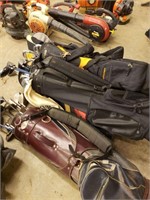 Golf bags with assorted clubs