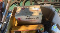 Box of antique train toys and parts