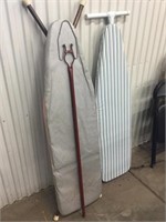 Two ironing boards and mop handle