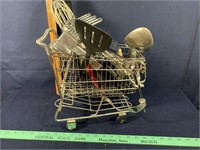 Metal shopping cart full of kitchen utensils
