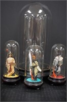 Asian figures under glass domes