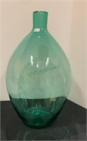 Large green glass hand blown bottle measuring 17