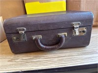 Vintage leather covered carry on suitcase