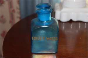 Blue toilet water bottle with note indicating