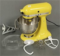 Yellow Kitchen Aid mixer with accessories