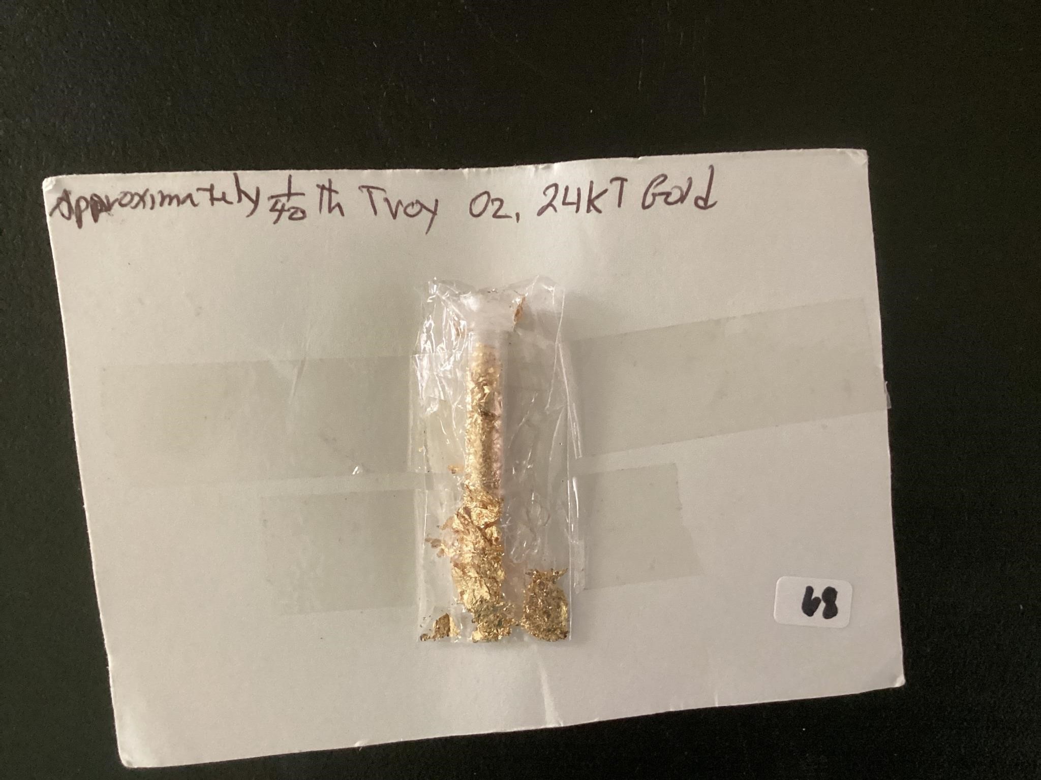 APPROXIMATELY 1/40 TRO OZ 24 KT GOLD FLAKES.