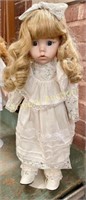 PORCELAIN DOLL W/ BOW IN HAIR