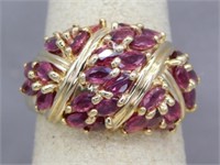 WIDE 10K RING WITH 3/4 CTTW RUBIES. SIZE 7.75.