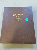 A collector book containing 28 Eisenhower dollar c