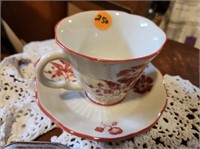 pretty red flowers & white teacup & saucer